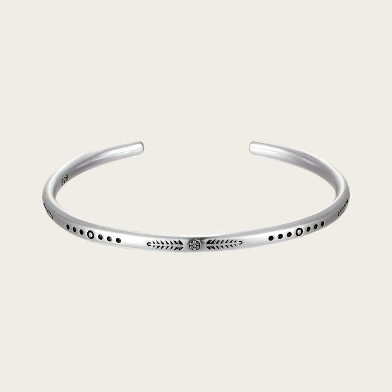 Minimalist silver cuff bracelet with engraved black details inspired by Brazil’s Noronha island.