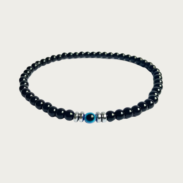 Black onyx beaded bracelet with blue evil eye and sterling silver, inspired by Brazilian style.