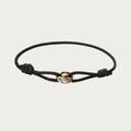Black silk cord bracelet with gold, rose gold, and silver trinity rings inspired by Brazilian style.