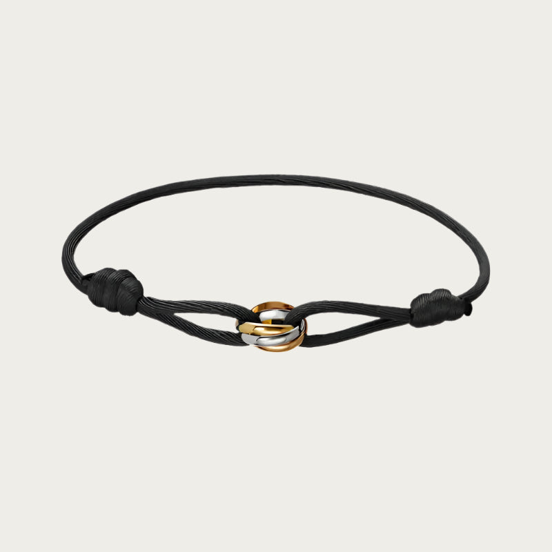 Black silk cord bracelet with gold, rose gold, and silver trinity rings inspired by Brazilian style.