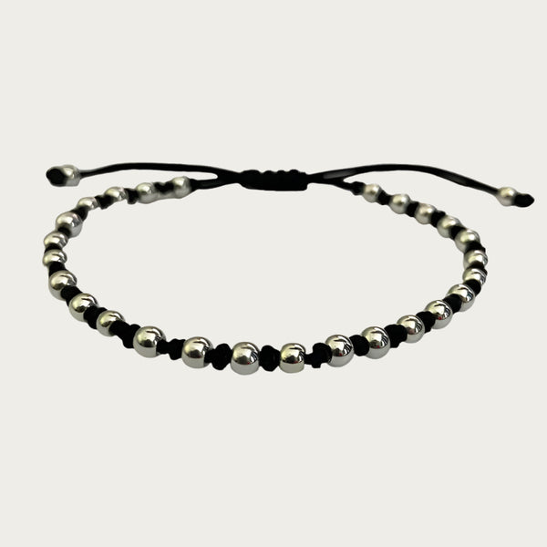 Beaded bracelet with silver-plated beads and black cord inspired by Brazilian design.