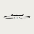 Black cord bracelet with rhodium eye charm inspired by Brazilian style and protection.