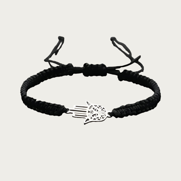 Red braided bracelet with stainless steel Hamsa pendant inspired by Brazilian summer and protection symbols.