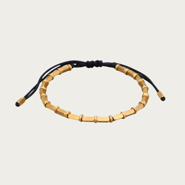Golden copper beaded bracelet with black cord inspired by Brazilian summer style.