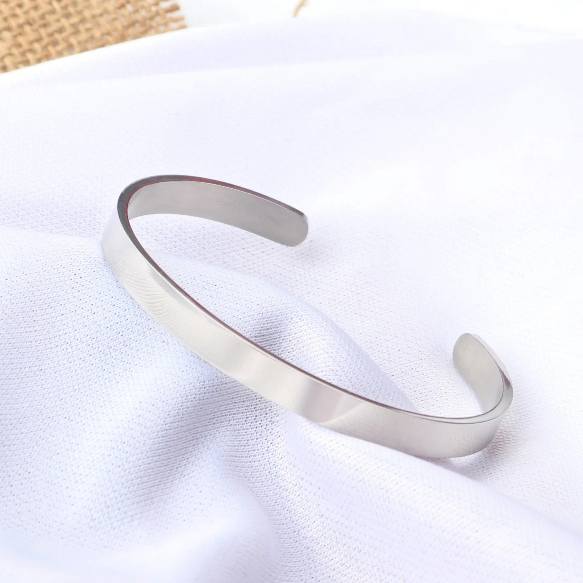 Minimalist silver-plated stainless steel cuff bracelet inspired by Sao Paulo’s modern style.